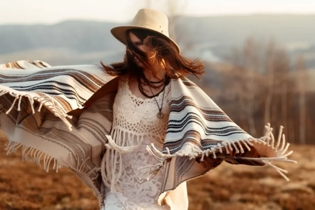 A woman wearing an Andean poncho dancing in a clearing